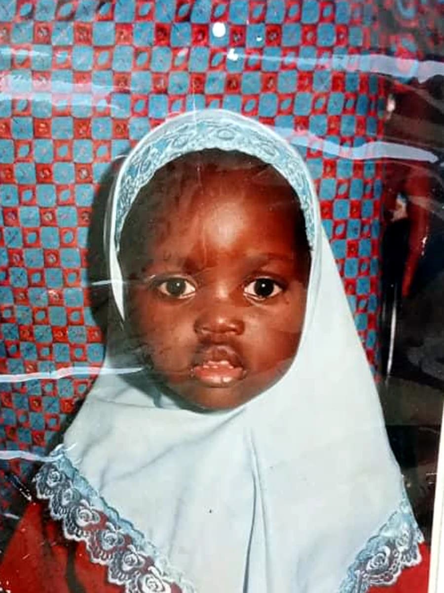 Sofiyyah as a small child, in a pale blue lace hijab